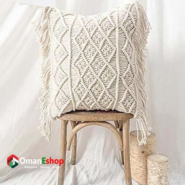 A handcrafted pillow and cushion cover from Oman E Shop, featuring intricate thread designs in warm, earthy tones, styled in a cozy living room setting.